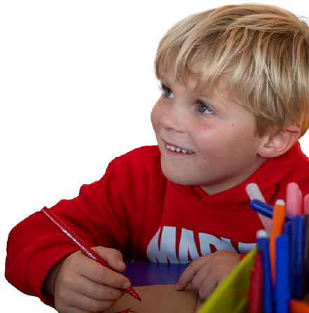 Little boy smiling and holding a red felt-tipped pen