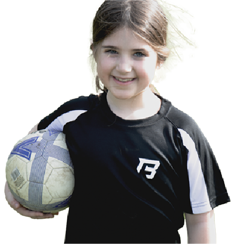 Girl wearing football kit and holding a football under her arm
