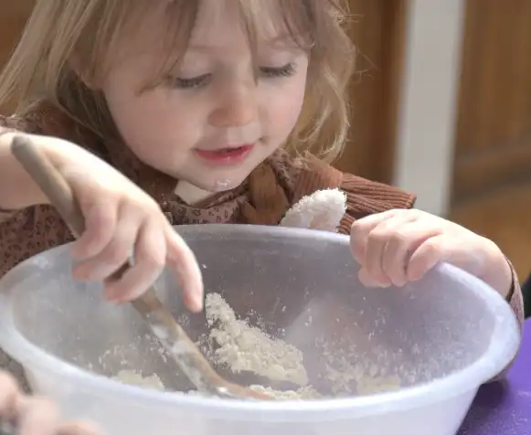 Little girl mixing cake batter