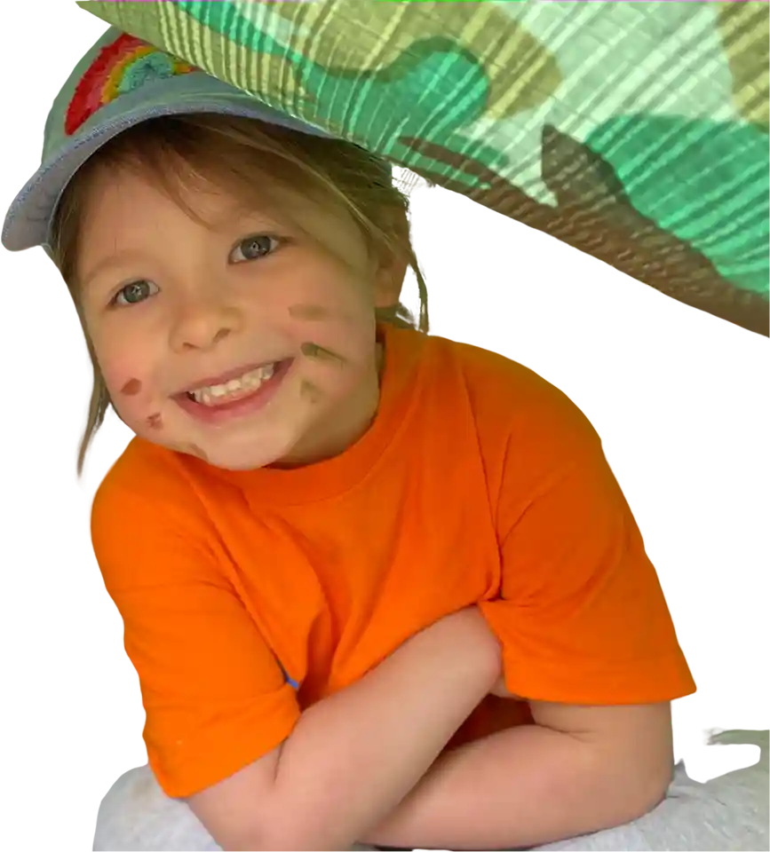 Young girl smiling, sitting in a tent